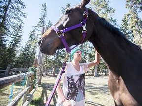 Sancia Trouillot prepares her horse Estelle for saddling at a stable at the Bow Valley Riding Association Thursday, May 9, 2013. After being diagnosed with Burkitt lymphoma, Trouillot reached out to the Make a Wish Foundation in the hopes of owning a horse, a lifelong dream of hers. Justin Parsons/ Canmore Leader/ QMI Agency