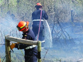 Strathcona County Emergency Services firefighters work to contain the wildfire in the north part of the county. Trent Wilkie/Sherwood Park News/ QMI AGENCY