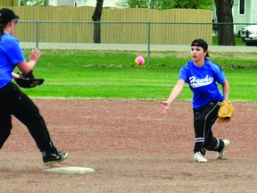 Hawk Jesse Mix tosses the softball to teammate Brianna McKay for an out during County Central’s first slo-pitch game of a double-header May 22 against Magrath High School at the diamond by the high school. Stephen Tipper Vulcan Advocate