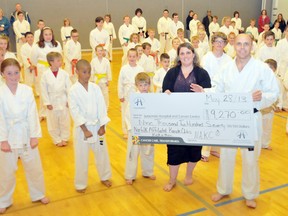 EDDIE CHAU Times-Reformer
Melissa Shuker, business and community engagement officer for the Juravinski Cancer Centre Foundation, receives a check from Sensei Marco Reyes of the Norfolk Affiliated Karate Clubs totaling $9,270. The money was raised to a variety of martial arts based fundraisers in April.