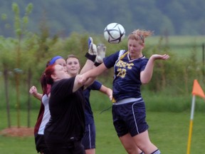 Emily Pepper, right, of the Pain Court Patriotes heads the ball past North Lambton Eagles keeper Alyssa Wolfe for Pain Court's third goal in the SWOSSAA "A" senior girls soccer semifinal Tuesday, May 28, 2013 at Taxandria Soccer Club in Warwick, Ont. PAUL OWEN/THE OBSERVER/QMI AGENCY