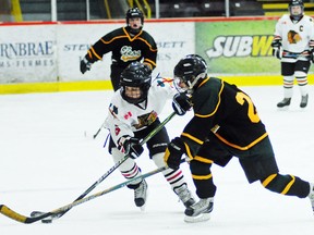 Brockville's Wyatt Gray taking the puck wide against an Alexandria Glens defenceman during the championship final in the C house division  at the Brockville Legion Peewee Hockey Tournament this past January. The division was the only one of the three local peewee divisions that was non-contact this past season in BMHA league play. (RECORDER AND TIMES FILE PHOTO)