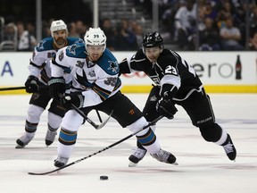 Logan Couture of the San Jose Sharks is pursued by Dustin Brown of the Los Angeles Kings during Game 7 of the Western Conference semifinals. (Getty)