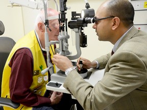 Dr. Krishna Rao, chief of ophthalmology at Trenton Memorial Hospital, demonstrates how to use the Slit Lamp – a new piece of equipment in the hospital's exam lane – which was recently purchased thanks to a $45,000 donation, presented by Brighton Lions Club Monday. Also shown is John Stephens Brighton Lions Club project coordinator. 
EMILY MOUNTNEY/TRENTONIAN/QMI AGENCY