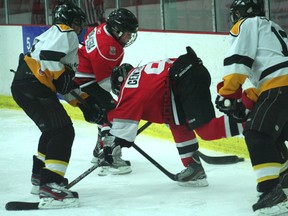 A Kenora Peewee Thistles player falls to the ice after a battle along the boards for the puck. Hockey Canada just passed a new rule eliminating body checking from Peewee divisions moving it up to the Bantam age in order to protect younger children from injury.
FILE PHOTO/Daily MIner and News
