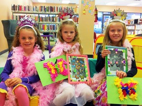 Sisters Miyah and Kiley Fehr (ages 6 and 8), flank their cousin Alyssa Fehr, age 9 during the Fancy Nancy Party at the Tillsonburg library.