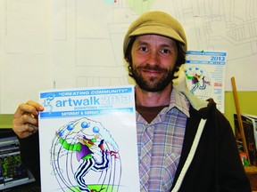 Artwalk organizer Shawn McKnight holds up the Art Walk event poster. Last year, Artwalk attracted roughly 25,000 people. This year, organizers are hoping to top that. (LIZ BERNIER, The Observer)