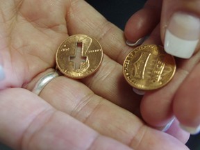 Cross pennies, like the one pictured on the left, have been turning up on the street in areas across Woodstock. CODI WILSON/WOODSTOCK SENTINEL-REVIEW