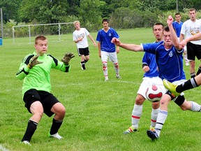 East Elgin's Ryan Herries, right, volleys home the Eagles' only goal Wednesday against Ingersoll goalkeeper Adam Palmer, left, in the TVRA South East soccer final at Columbus Park. Ingersoll took the title with a 2-1 victory and claimed the league's spot in the WOSSAA AAA tournament on Friday in London. R. MARK BUTTERWICK / St. Thomas Times-Journal / QMI AGENCY