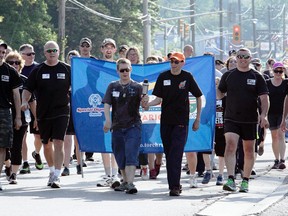 SARAH DOKTOR Simcoe Reformer
Kyle Reeves and Jason Gordy carried the Special Olympics torch up the Queensway in Simcoe during the annual Law Enforcement Torch Run on Wednesday.