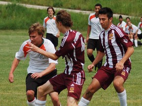 North Park's Jake Moore attempts to drive through a pair of Preston High School Panthers on Wednesday during the Central Western Ontario Secondary School Association boys AAA championships at John Wright Park. (DARRYL G. SMART, The Expositor)