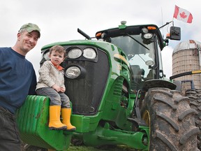 Steve Sickle, president of the Brant County Federation of Agriculture, poses with his 2 1/2-year-old son, Ethan. Sickle says "there is a new influx of young blood in farming because it looks more prosperous at the moment." (BRIAN THOMPSON, The Expositor)