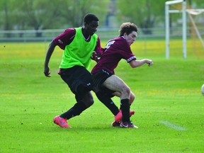 Keith Appah, left, of the Trojans scores PCI's second goal of the evening during PCI's game against Westwood on May 29. (Kevin Hirschfield/THE GRAPHIC/QMI AGENCY)