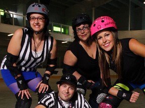 Roller derby coach Keith Hotte sits below referee Holly Rogers, left, and players Erikka Mutton and Sherry Hotte, his wife, at the Quinte Sports and Wellness Centre in Belleville last Friday. They're hoping to register at least a dozen more players for a Belleville team.