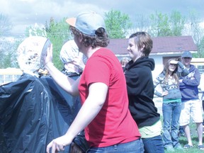 Harry Slade and Stephanie Irnie get the honour of throwing cream pies in the faces of teachers Charlene Baxter and Sue Moore. The event was a fundraiser, with monies going to support the school's sponsored school in Africa.