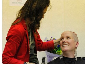Michelle Yule (left) and Dawn-Marie Cinnamon share a look following Cinnamon’s head shave on May 25. Through donations and auctions, Cinnamon has raised over $10,100 for Kids Cancer Care.