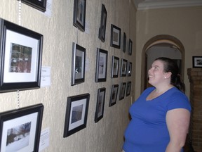 Sarah Nemcsok, Museum of Northern History Collections Assistant, stops to view some of the photos and captions in the Voice projects sponsored by the Canadian Mental Health Association.