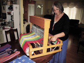 Devon resident Georgette “Bunny” Lilley weaving a Metis sash at her loom.