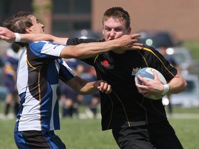 Saugeen District Royals' Colton Hall gets straight armed by  the Erin District High School Raider's Jackson Smith as he tries to break away with the ball during the  CWOSSA boys Rugby final on Thursday, May 30, 2013 at SDSS in Port Elgin.