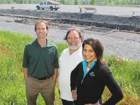 Westbrook Golf Club owners Anita Harnden, right, Ken Harden, centre, and manager Marco Smits stand next to the site of the new sports dome, where construction on the long-delayed project resumed this week.
Elliot Ferguson The Whig-Standard