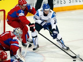 Russia's Anton Belov, No. 7, chases Finland's Janne Pesonen during a round-robin game at the IIHF Ice Hockey World Championship in Helsinki May 10. (Reuters)