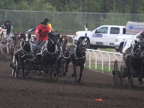 Lane Kimble (right) and Sean Debolt finished 1-2 in their heat and on the night at the Western Chuckwagon Association races on Thursday, May 30, 2013 at the Grande Prairie Stompede in Grande Prairie, Alberta. Kimble won Heat 5 by one-one-hundredth of a second over Debolt. The WCA races continue through the weekend at the Grande Prairie Stompede.