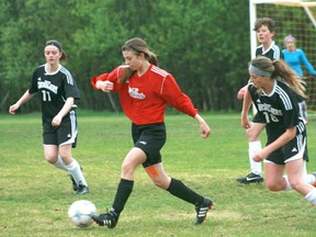 St. Thomas Aquinas's Tori Stebnitsky dribbles the ball back into the centre of the field during the Saints game against Wawa's Ecole Saint Joseph. The Saints defeated the Chevaliers 1-0 in the first game of the NWOSSAA finals best of three series. The second game takes place Friday, May 31 at 4 p.m. at St. Thomas Aquinas. 
GRACE PROTOPAPAS/KENORA DAILY MINER AND NEWS/QMI AGENCY