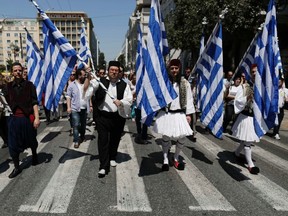 Municipal workers dressed in traditional costumes protest against the government’s plan to layoff thousands of public sector workers as part of its austerity reform program, in Athens April 26, 2013. (REUTERS/John Kolesidis)