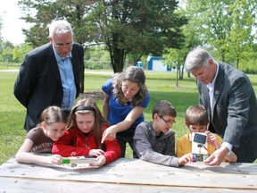 A new alternative energy education program is now available to area students through the St. Clair Region Conservation Authority and Enbridge. Pictured are Tecumseh Public School students Julia Caron, Kathleen Boorman, Bradley Hutching, and Corey Lauzon looking at solar mini-boats they will be using later in the program. Also pictured are Ken Hall, Senior Advisor - Community Relations Eastern Region Enbridge Pipelines Inc., Melissa Gill, Conservation Education Instructor with the St. Clair Region Conservation Authority, and Steve Arnold, Chair of the St. Clair Region Conservation Authority. (Submitted photo)
