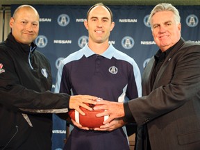 Argos QB Ricky Ray, flanked by coach Scott Milanovich (left) and GM Jim Barker, signed an extension Friday that will keep him in Double Blue through the 2015 season. (Veronica Henri, Toronto Sun)