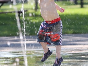 Jayden Watson 3 1/2 has a good time running through the waterpark at City Park on Friday. He was there with his mom Christa. About two dozen parents and children were enjoying the park during Friday's warm temperatures.
Ian MacAlpine The Whig-Standard