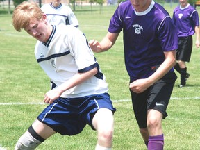 Joihn Alves, right of the West Elgin Wildcats, defends against a London District Christian Pioneer in the WOSSAA A soccer final Friday in West Lorne. LDCSS won 4-0. (PATRICK BRENNAN, QMI Agency)