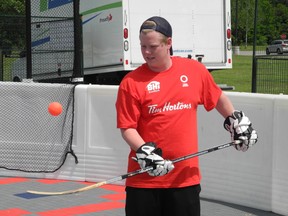 PJ Fulsom, 19, of Brantford, gets warmed up for the Walter Gretzky Street Hockey Tournament on Friday. The tournament has attracted 153 teams including some from Illinois and New York State. Play began Friday night and continues all day Saturday and into Sunday. (VINCENT BALL Brantford Expositor)