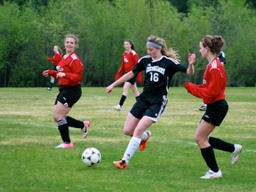 St Thomas Aquinas's Gilly Derouard, left, looks on as teammate Tess Derouard steps up to challenge an Ecole Saint Joseph player. The Saints defeated the team from Wawa 1-0 and 5-1 to win NWOSSAA and earn a berth to OFSAA on Friday, May 31. 

GRACE PROTOPAPAS/KENORA DAILY MINER AND NEWS