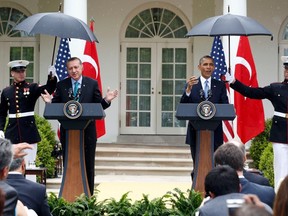 U.S. Marines shelter President Barack Obama and Turkish Prime Minister Recep Tayyip Erdogan at a recent White House press conference. Turkey is pressing the Americans to take a stronger stance on the civil war in Syria as it increasingly spills across Syria's borders and risks destabilizing the entire region.