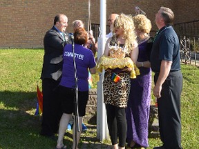 Elliot Lake Mayor Rick Hamilton, assisted by several councillors and members of the LGBT community including Michelle DuBerry - a drag queen dubbed empress of Toronto, raise the Rainbow Flag outside of city hall Friday evening.
Photo by KEVIN McSHEFFREY/THE STANDARD/QMI AGENCY