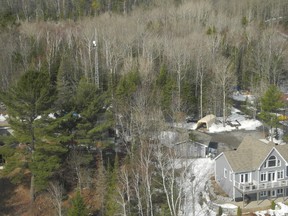 Laura Stricker photo. A telecommunications tower, built by Greater Sudbury Utilities, sits on Greater Sudbury Hydro CEO Frank Kallonen's property. The house shown in the photo is not Kallonen's.