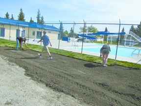 Mayerthorpe`s outdoor swimming pool is filled with water and final steps to complete it continued with Romeo’s Landscaping and Construction of Mayerthorpe placing grass at the side along 54 Street. At work on Wednesday, May 22, were, from left, Martin