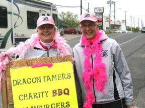 Cindy Zabloski, left and Diane Pochailo, right hold up a sign for the Dragon Tamers BBQ decked out in their bright pink boas. The annual BBQ is from 11:00 am till 2:30 pm today across from Q104 on Lakeview Drive. 

GRACE PROTOPAPAS/KENORA DAILY MINER AND NEWS