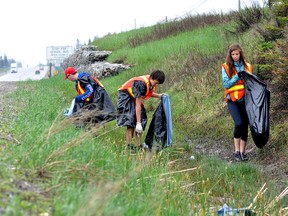 For 19 years, the South Porcupine Lions Club has teamed up with Roland Michener Secondary School and several members of the community to clean up the stretch of highway from the flags in Schumacher all the way to the OPP detachment. RMSS students, from left, Owen Hicks, Dustin Boucher and Sarah Carello lent a hand in the cleanup efforts on Saturday.
