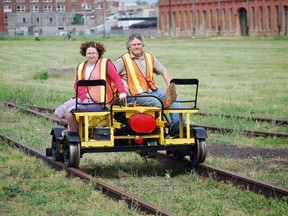 Dave Greve and daughter Amy of Woodstock make their way down a railway track with a gas-powered 1952 Fairmont M9 motor car, which track inspectors used to check rail conditions. BEN FORREST / THE ST. THOMAS TIMES-JOURNAL / QMI AGENCY