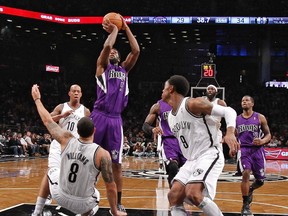 Brooklyn Nets guard Deron Williams (8) falls down as Sacramento Kings forward John Salmons (5) takes a shot in the first half of their NBA basketball game in New York January 5, 2013. (REUTERS/Ray Stubblebine)