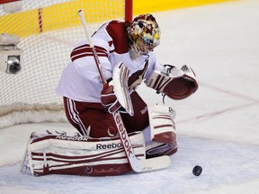 Phoenix Coyotes goalie Mike Smith makes a save during the first period of their NHL hockey game against the Calgary Flames in Calgary, Alberta, April 12, 2013. (REUTERS)