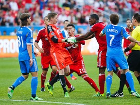 TFC’s Doneil Henry (right) gets into a shoving match with Philadelphia Union goalkeeper Zac MacMath during their game at BMO Field yesterday. (Ernest Doroszuk/Toronto Sun)
