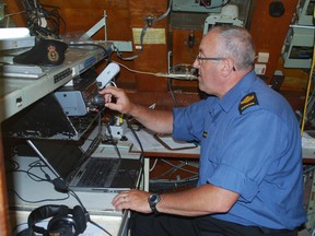 Petty officer Kevin Clements of the Royal Canadian Navy mans a radio room aboard the HMCS Ojibwa in Port Burwell on Saturday. Clements was part of Museum Ships Radio Weekend, which allowed members of the public to communicate with over 100 museum ships around the world. (Ben Forrest, Times-Journal)