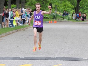 Kevin Blackney raises his arm in triumph as he crosses the finish line in first place at the 36th Annual YMCA/CHOK International Bridge Race Sunday in Canatara Park. The 21-year-old Port Perry, Ont. native finished the 10k race in 34 minutes. TYLER KULA/ THE OBSERVER/ QMI AGENCY