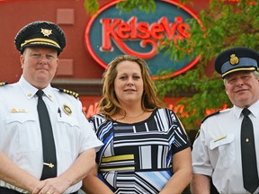 Tillsonburg Fire Services and Oxford OPP (Tillsonburg) will be going head-to-head, or more accurately 'wing-to-wing' on Tuesday, June 11 in the first-ever Kelsey's Restaurant Guns vs Hoses Wing Eating Contest, which will see a portion of the proceeds donated by Kelsey's to the winner of the wing-eating contest. From left are Tillsonburg Fire Services Chief Jeff Smith, Kelsey's Manager (guest experience) Kendall Causyn, and Oxford OPP Inspector Tim Clark. CHRIS ABBOTT/TILLSONBURG NEWS