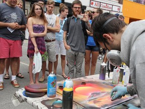 Chris Seaton, of London's Spraypaint Creations, creates a painting at Artwalk in downtown Sarnia Saturday. The 29-year-old drew crowds with speedy live demonstrations, finishing paintings in mere minutes. TYLER KULA/ THE OBSERVER/ QMI AGENCY