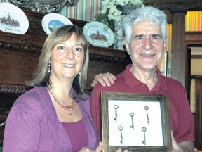 Elena Pastura and Dom Tassielli hold the original keys to Birmingham Manor, now a Bed and Breakfast, Saturday during Doors Open. The house was built in 1905 by John L. Youngs, the same builder who constructed City Hall and St. Andrew's Presbyterian Church. (LAURA CUDWORTH, The Beacon Herald)