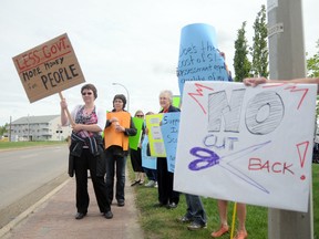 Johanne Leman (left) was joined by her sister Celeste Olsenberg (orange sign) as well as fellow protestors on Friday, to raise awareness about provincial funding cuts that will impact the community access supports within Persons with Developmental Disabilities.
Kirsten Goruk/Daily Herald-Tribune